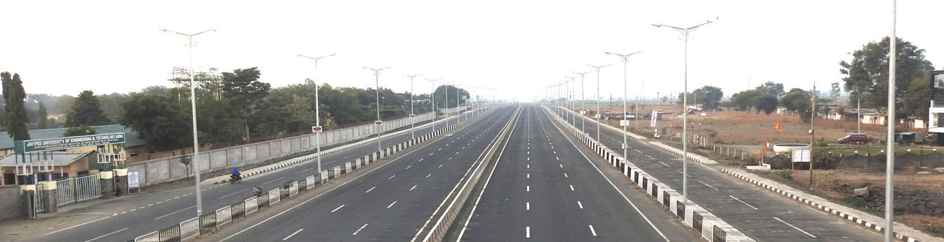 Six Lane Highway (NH-3) with 2 Lane Service Road each side in front of University gate